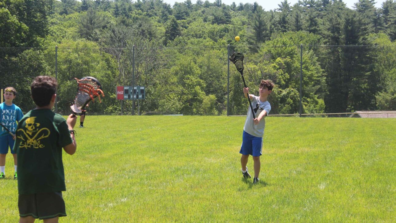 A camper playing lacrosse.