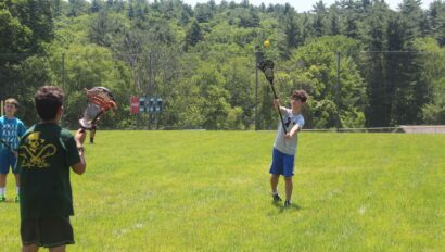A camper playing lacrosse.