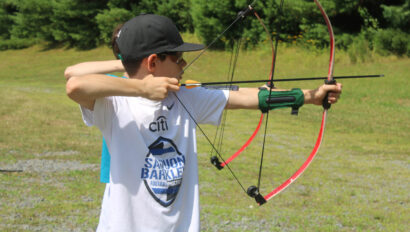 A camper practicing archery.