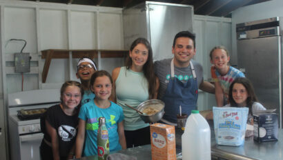 A group of campers cooking.