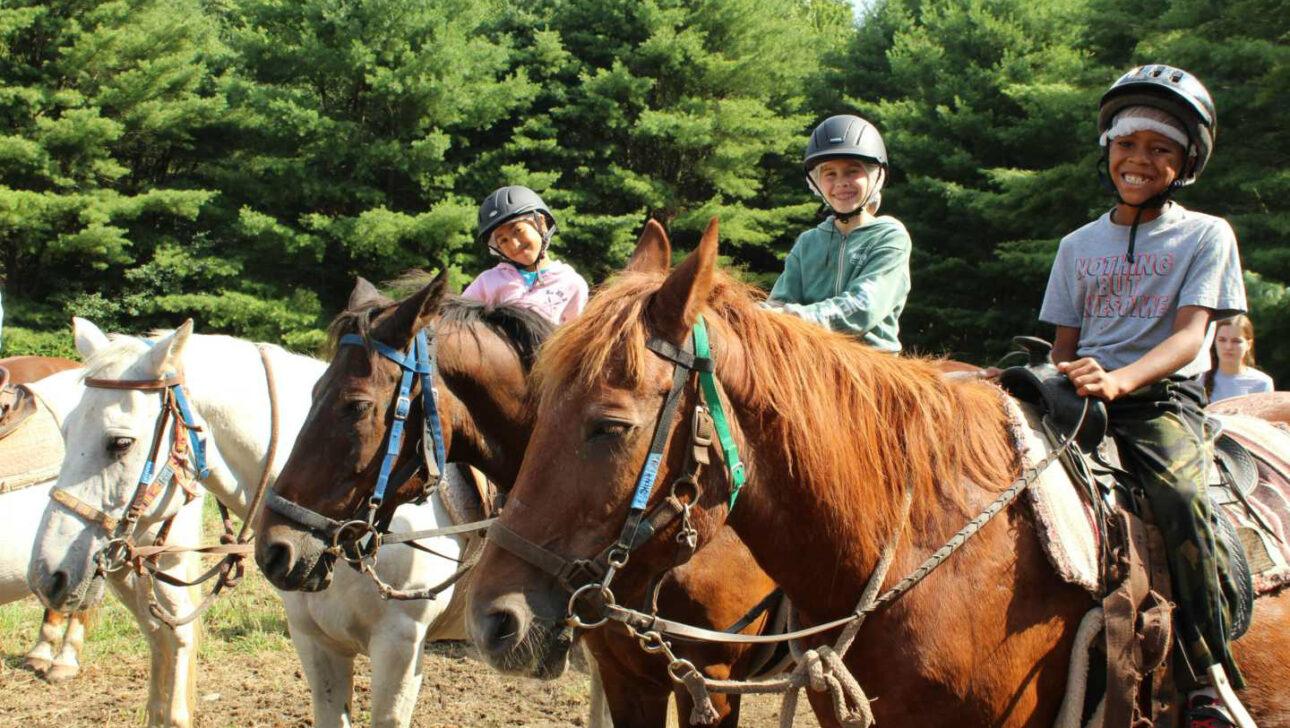 Campers horseback riding.