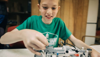 A camper working on Lego robotics and coding.