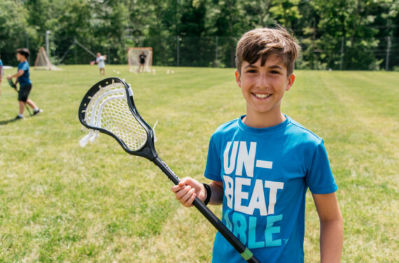 A camper ready to play lacrosse.