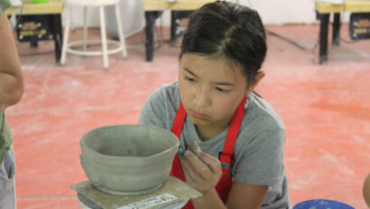 A camper working on pottery.