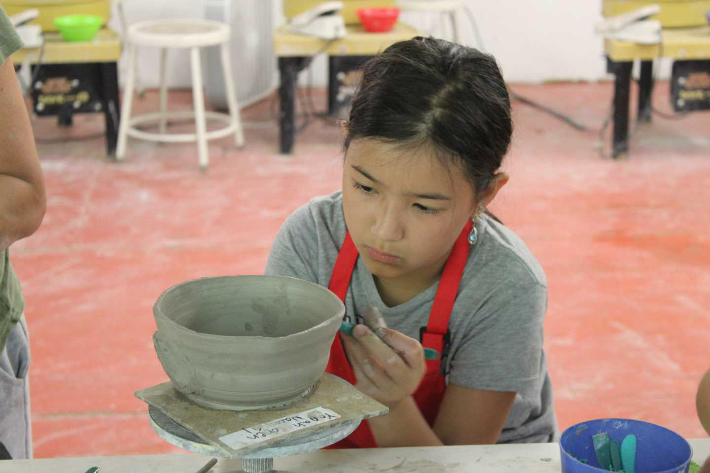 A camper working on pottery.
