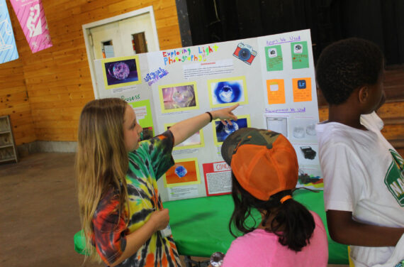 Campers presenting at a science fair.